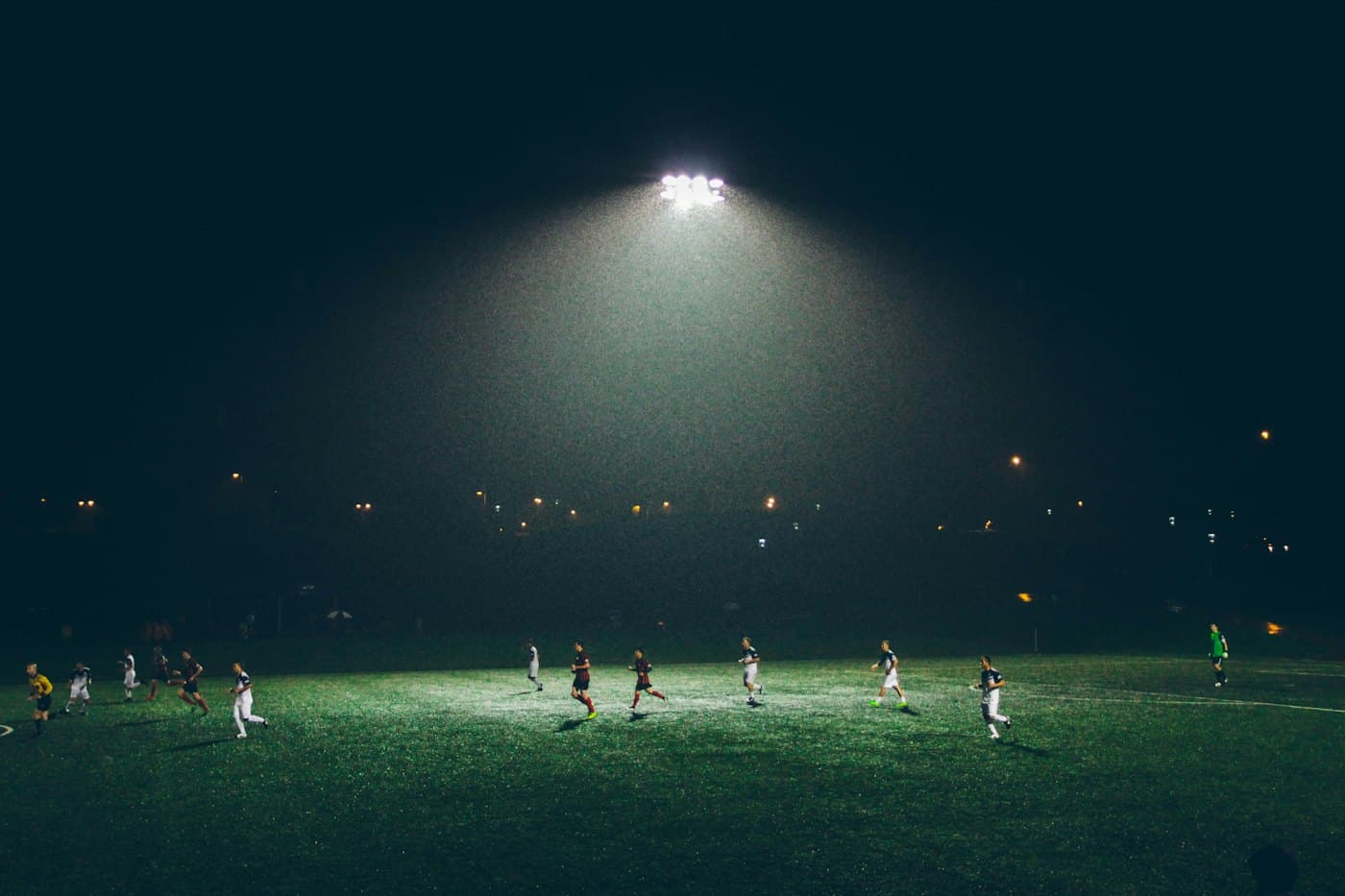 Amateur football on a floodlit pitch at night