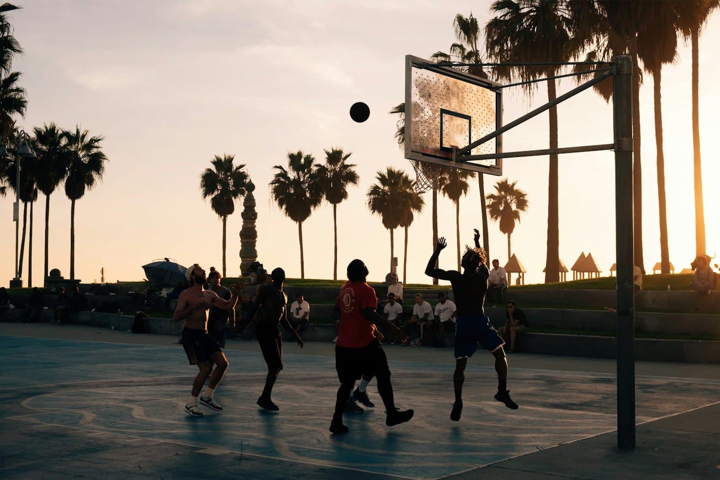 Pickup basketball game at sunset