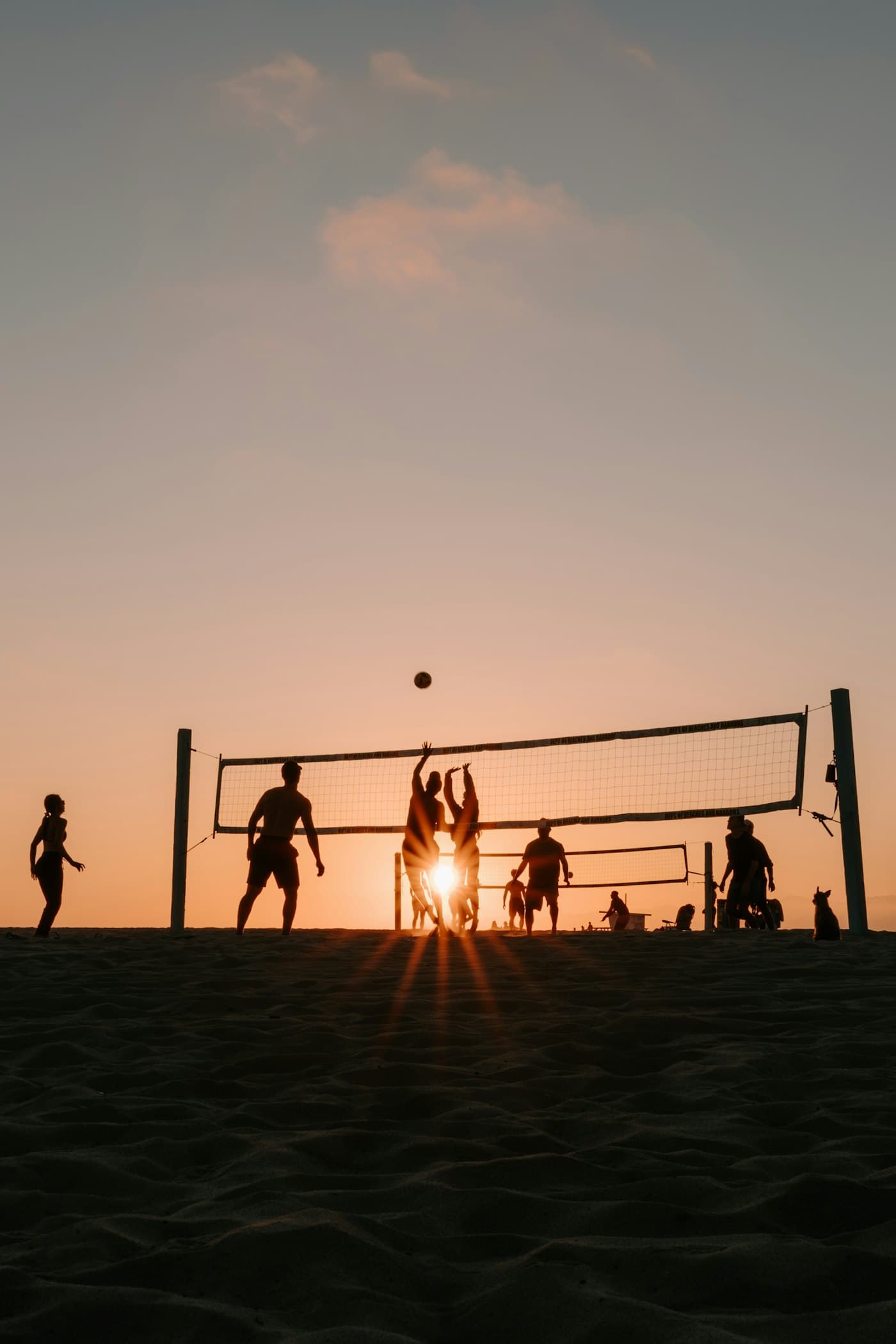 Beach volleyball at sunset